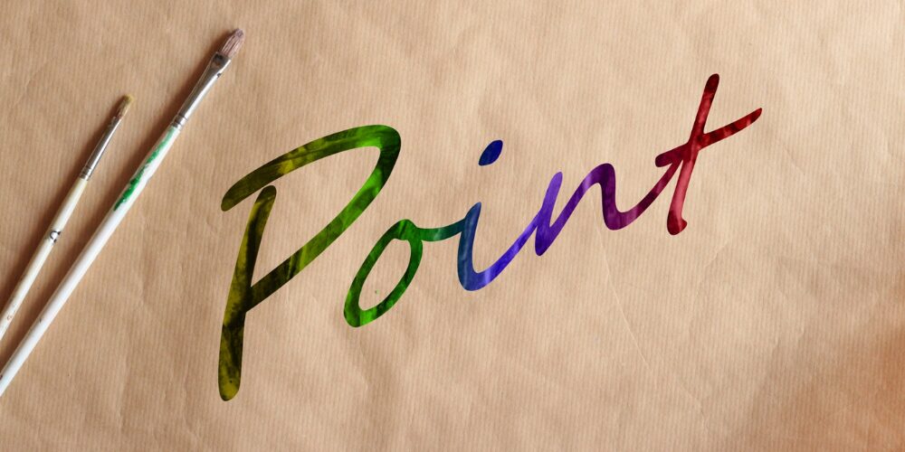 「Point」という英単語がカラフルな水彩調で描かれており、隣には絵筆が2本並べられています。